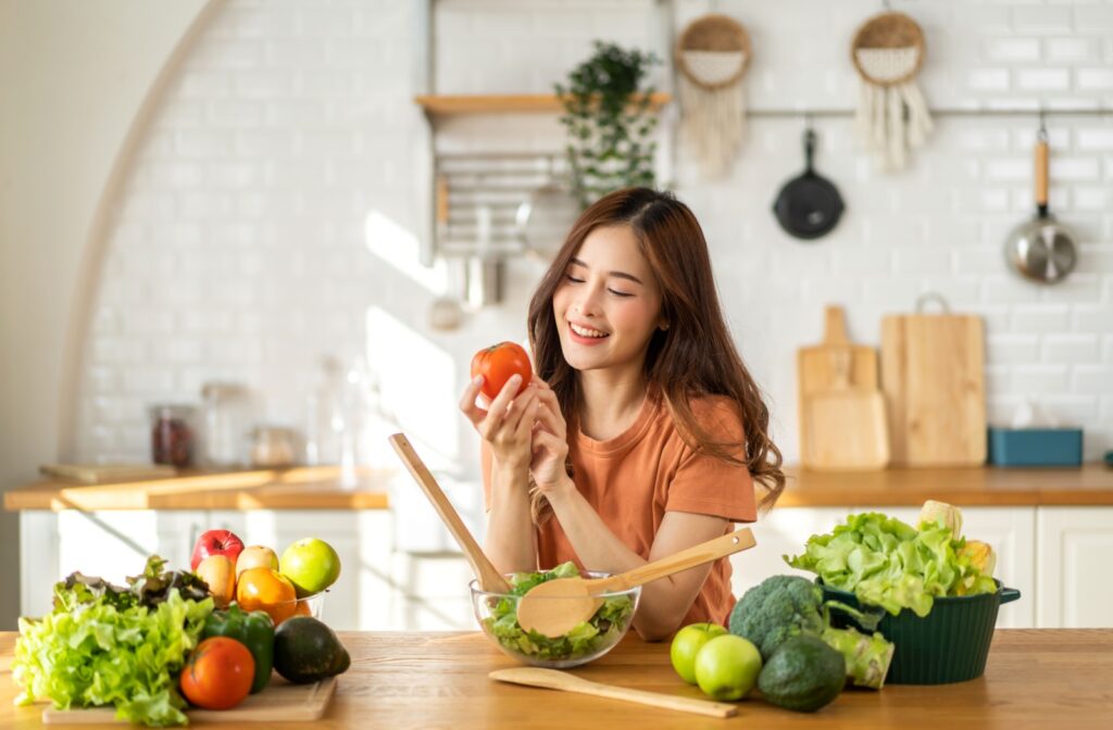 Woman eating fresh fruits and vegetables for better eye health.