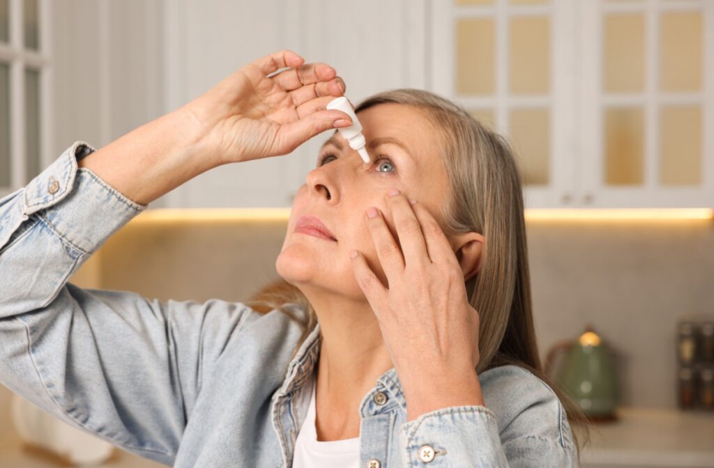 A person putting in eye drops
