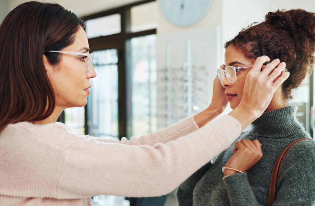 An optician adjusting a patients glasses at an optometry office.